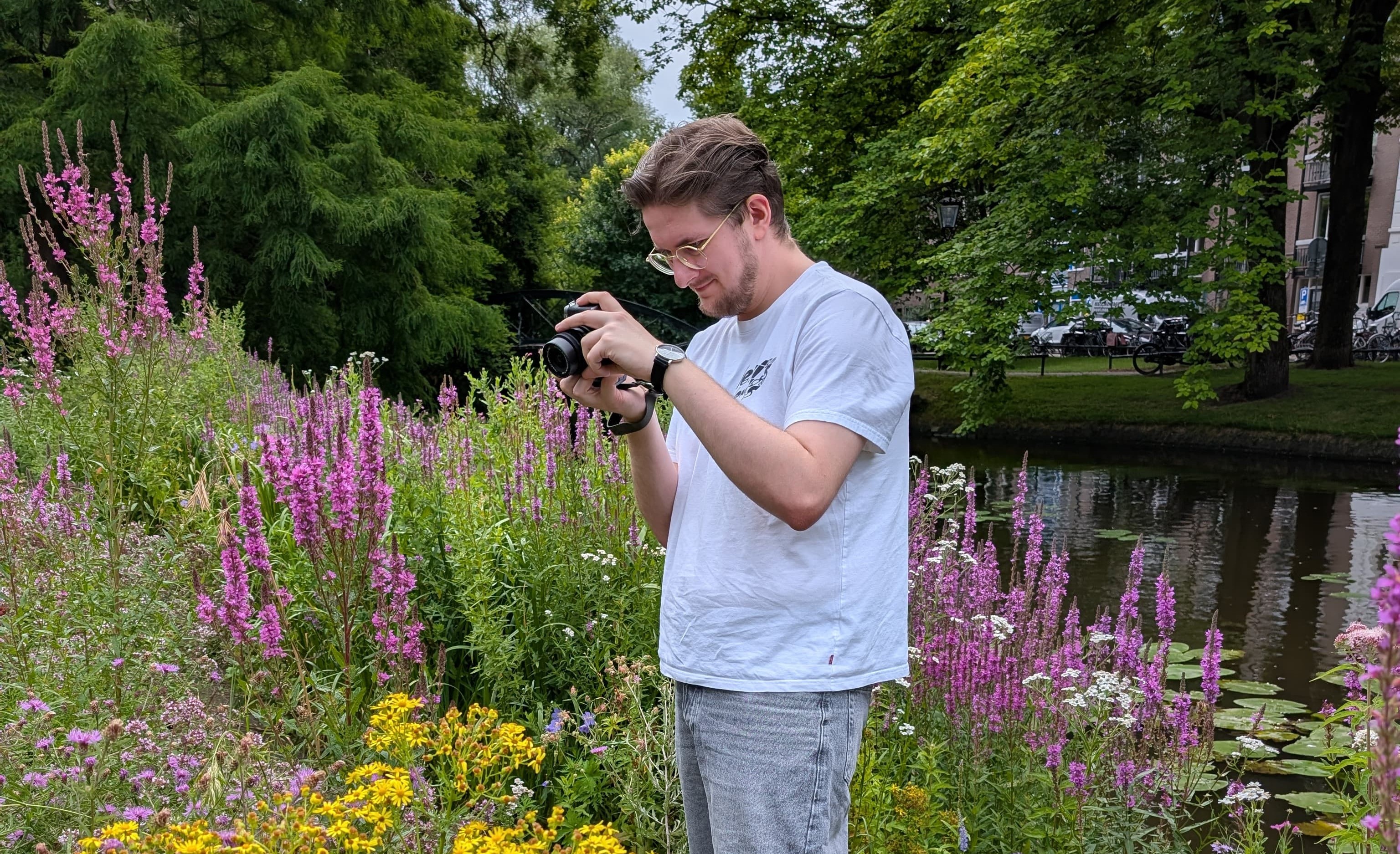 me with a camera in a colorful plant garden
