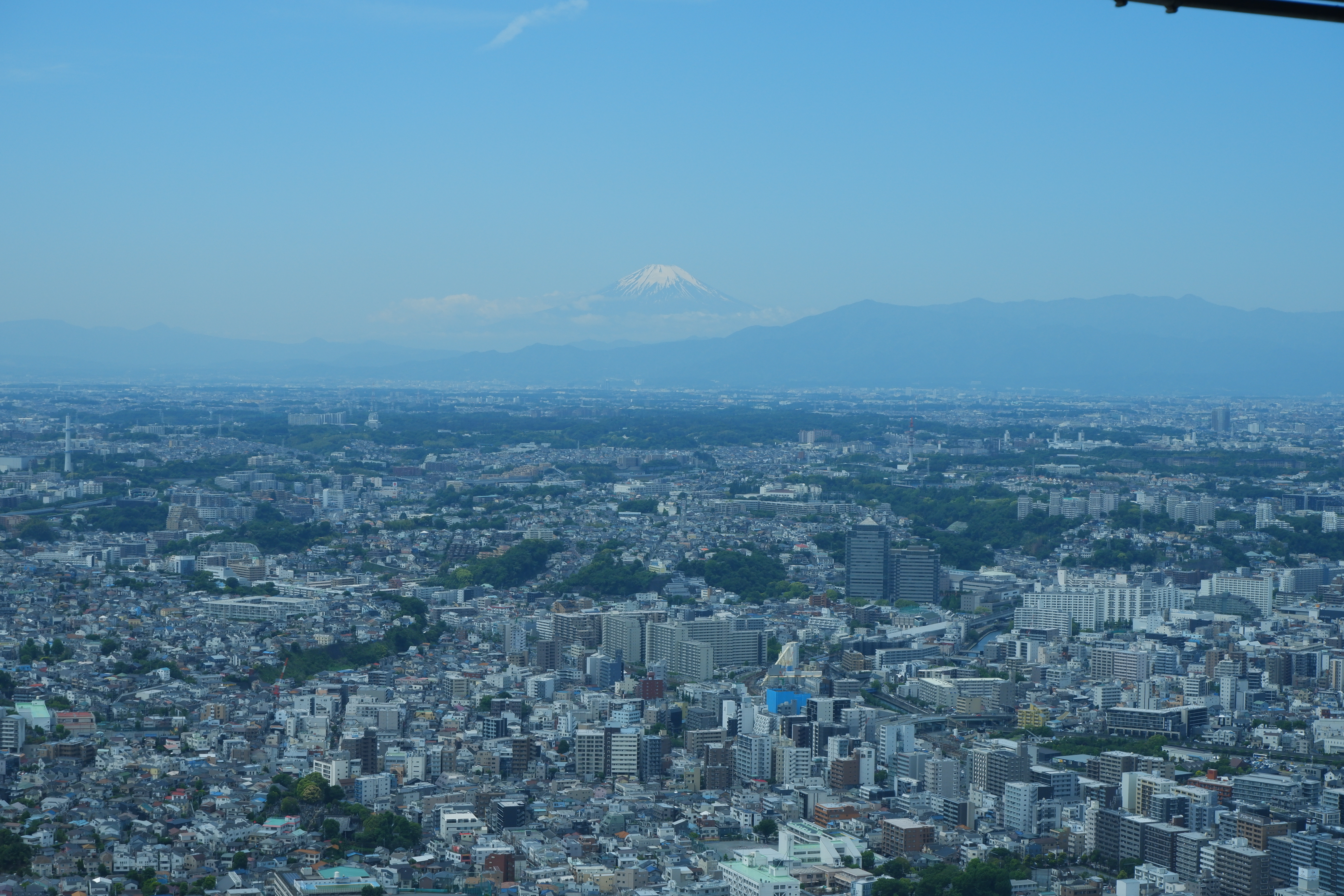a view over a city (Yokohama) with Mt. Fuji in the background