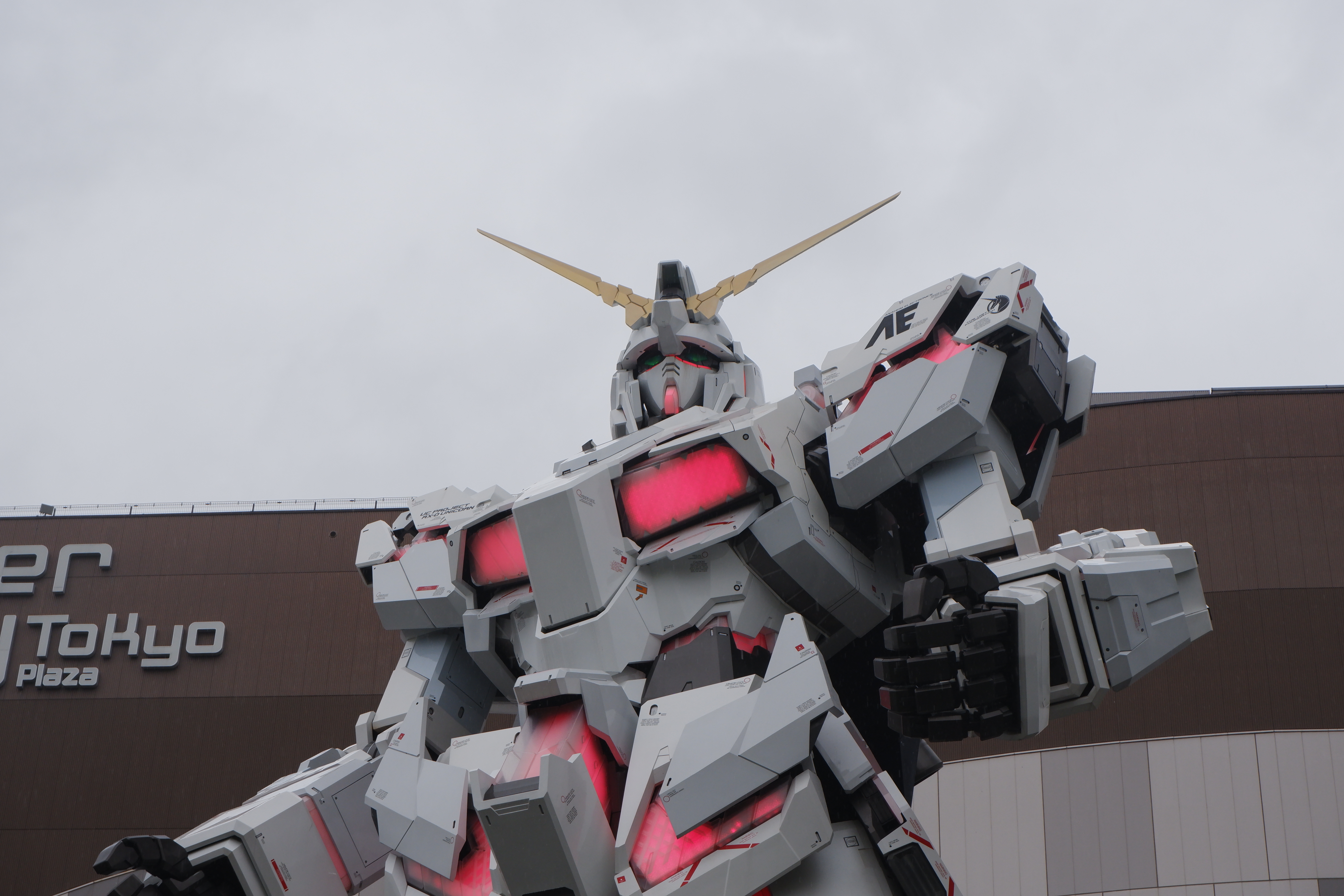 a close-up of of the big robot statue outside of the Odaiba Shopping mall, it lights up with red light in various places