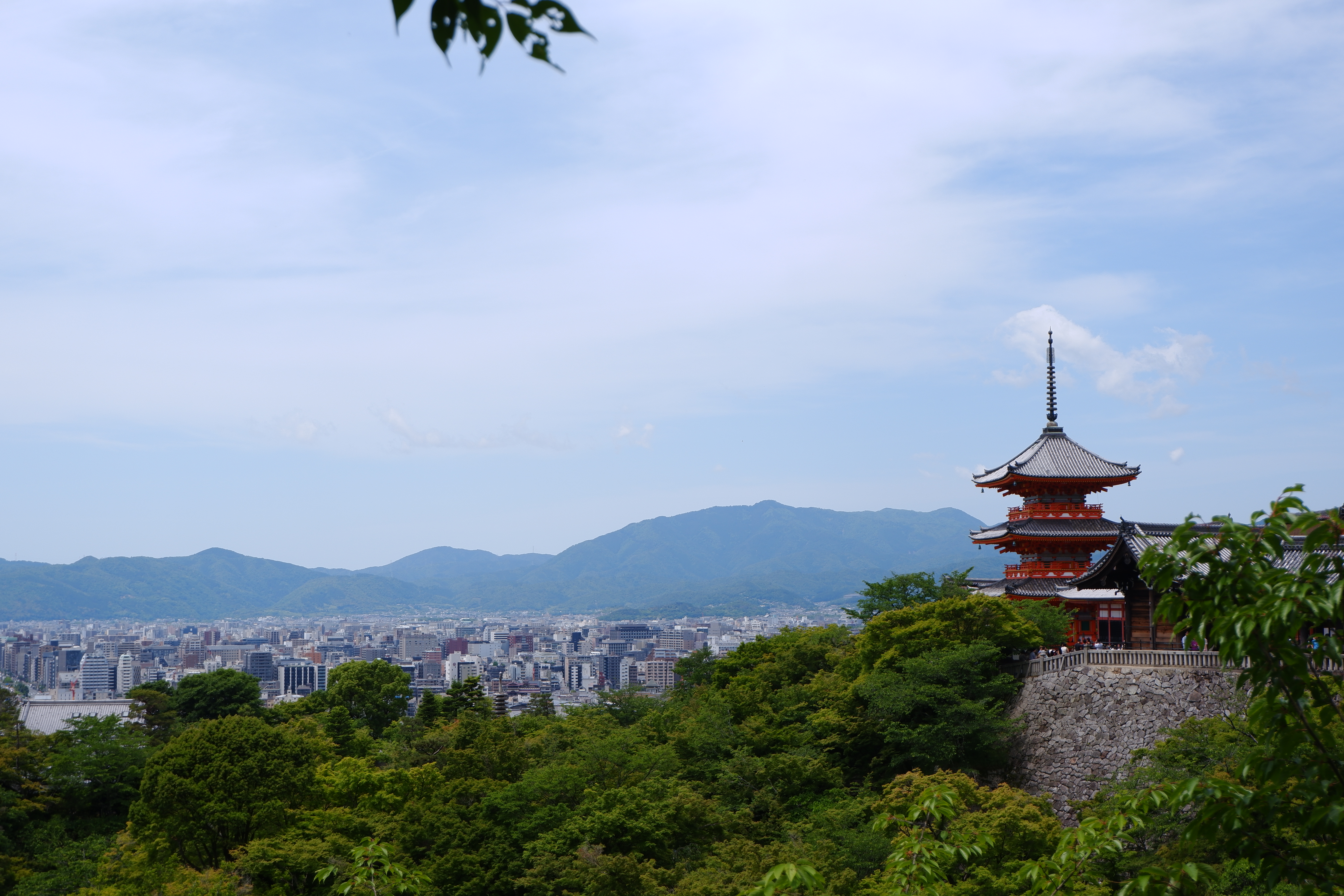 a view over Kyoto with a red pagoda tower off to the rigth