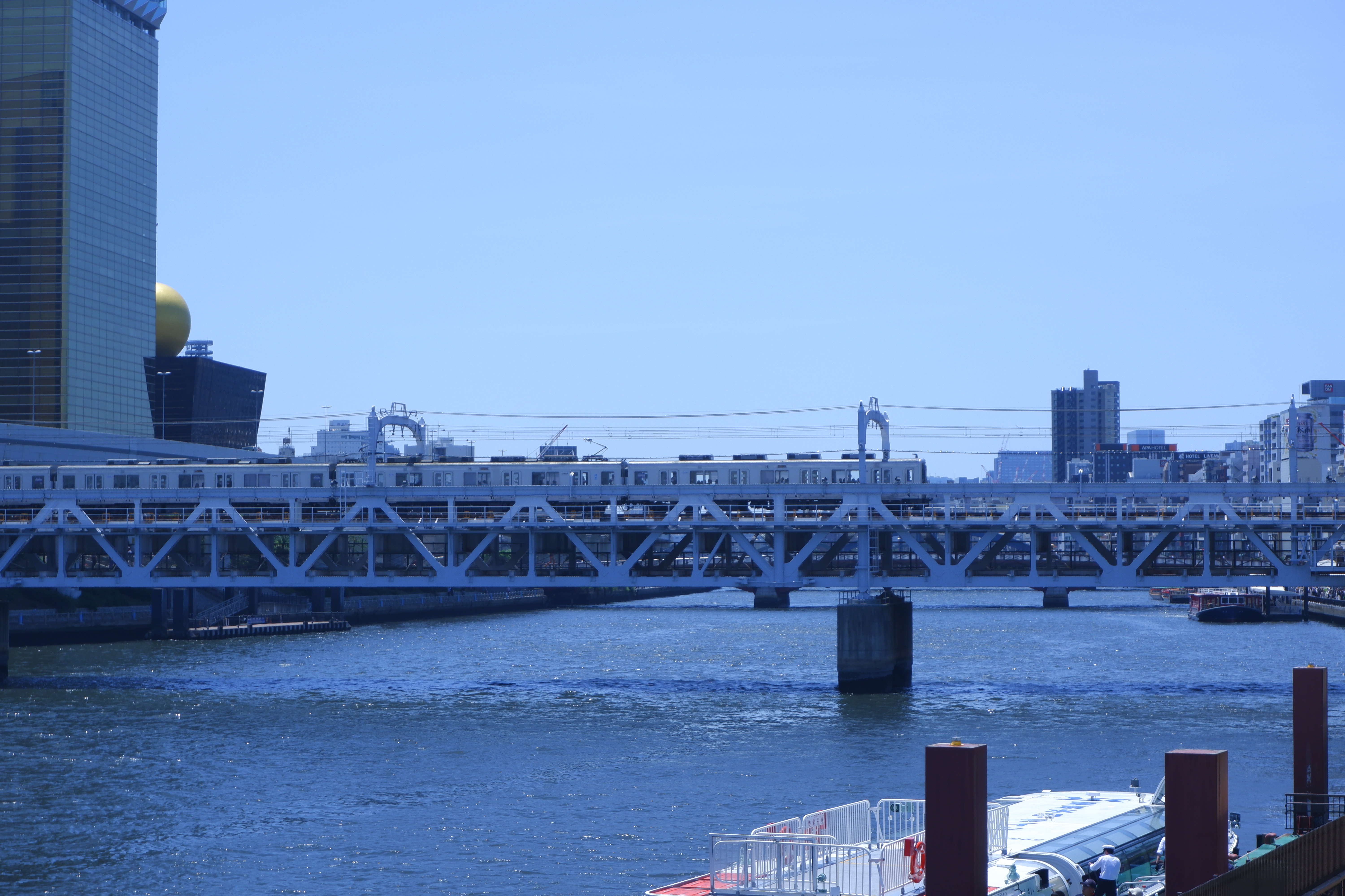 a metro over water, crossing on a bridge
